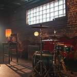 An album cover with the words 'Who Shot John' in all caps across the top and 'the frame' in all lowercase at the bottom. In the middle is an explosion of many different colors and a guy with a beard holding a guitar